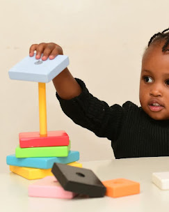 Colourful letter tiles and wooden toys on a classroom table