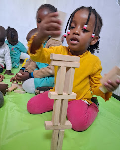 Toddlers building with wooden blocks at Gratia